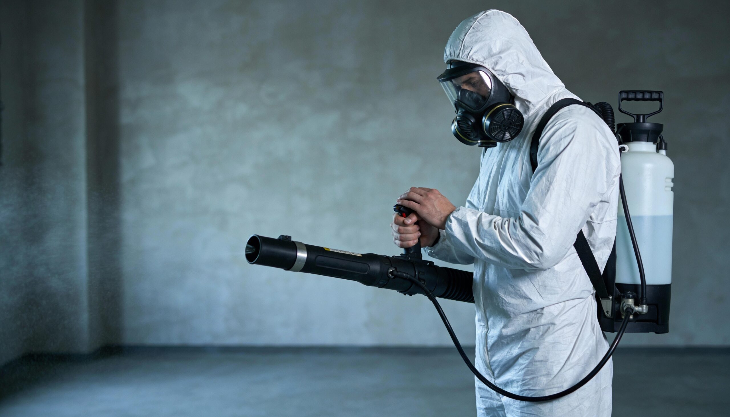 Professional trauma scene cleanup technician in full protective equipment